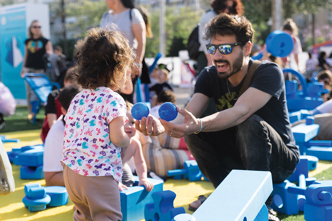 Father playing with child at pop-up play event in Tel Aviv