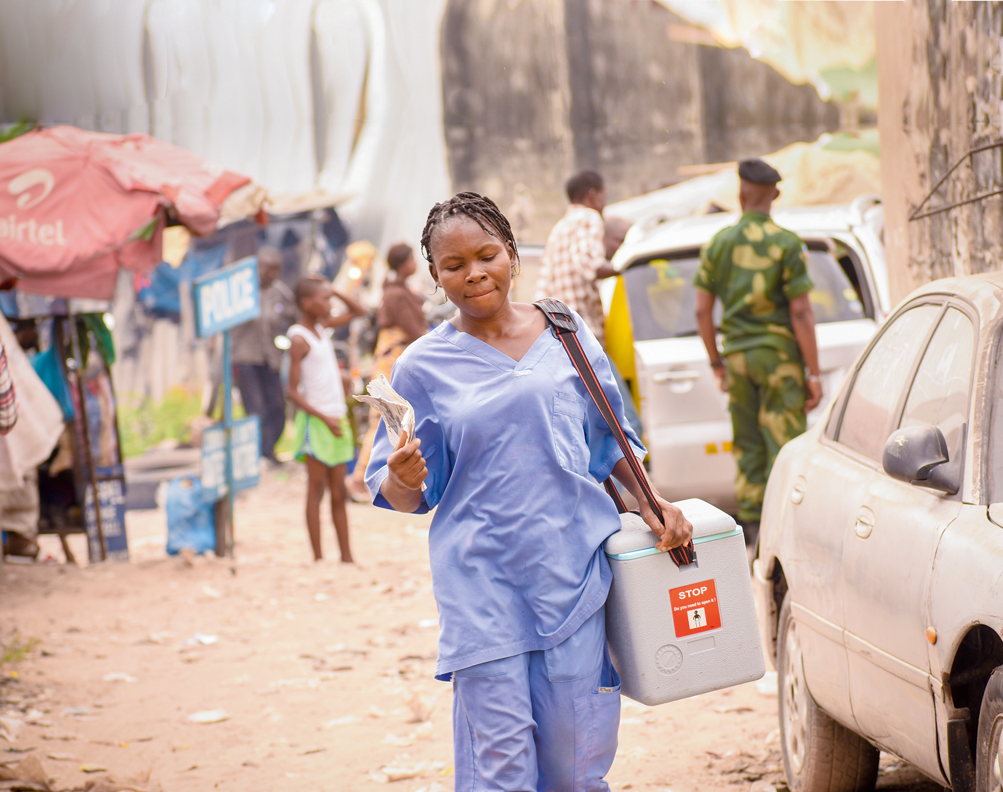 a health worker transports the day's vaccines from the health zone's central bureau to the health facility in Kinshasa.
