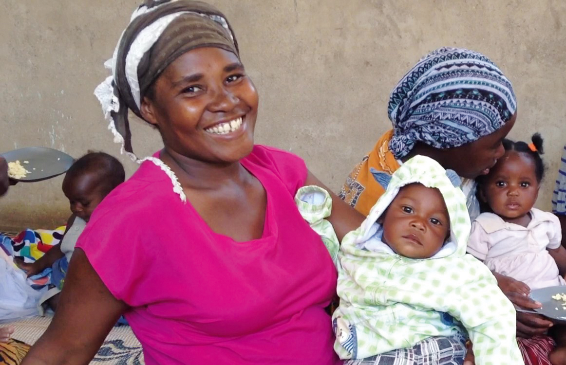 Ugandan mother carrying her baby